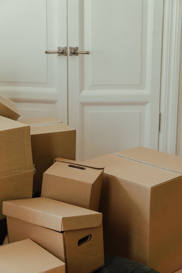 About Cardboard boxes stacked in an apartment, signifying a move-in or relocation process.